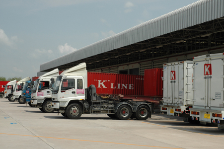 A photo of trucks lined up in a warehouse.