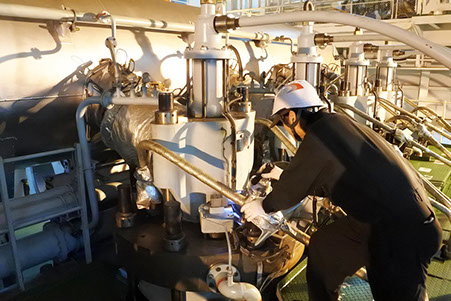 A maritime officer is operating machines on board.