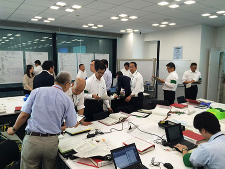Our employees conducting an emergency response drill in a conference room.