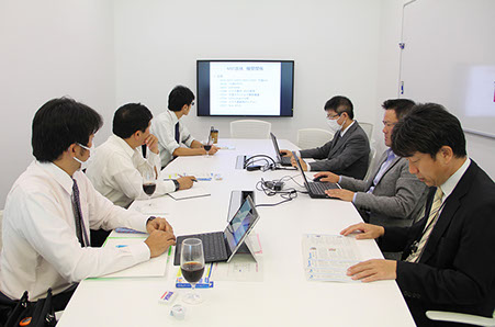 Our male employees meeting in the conference room.